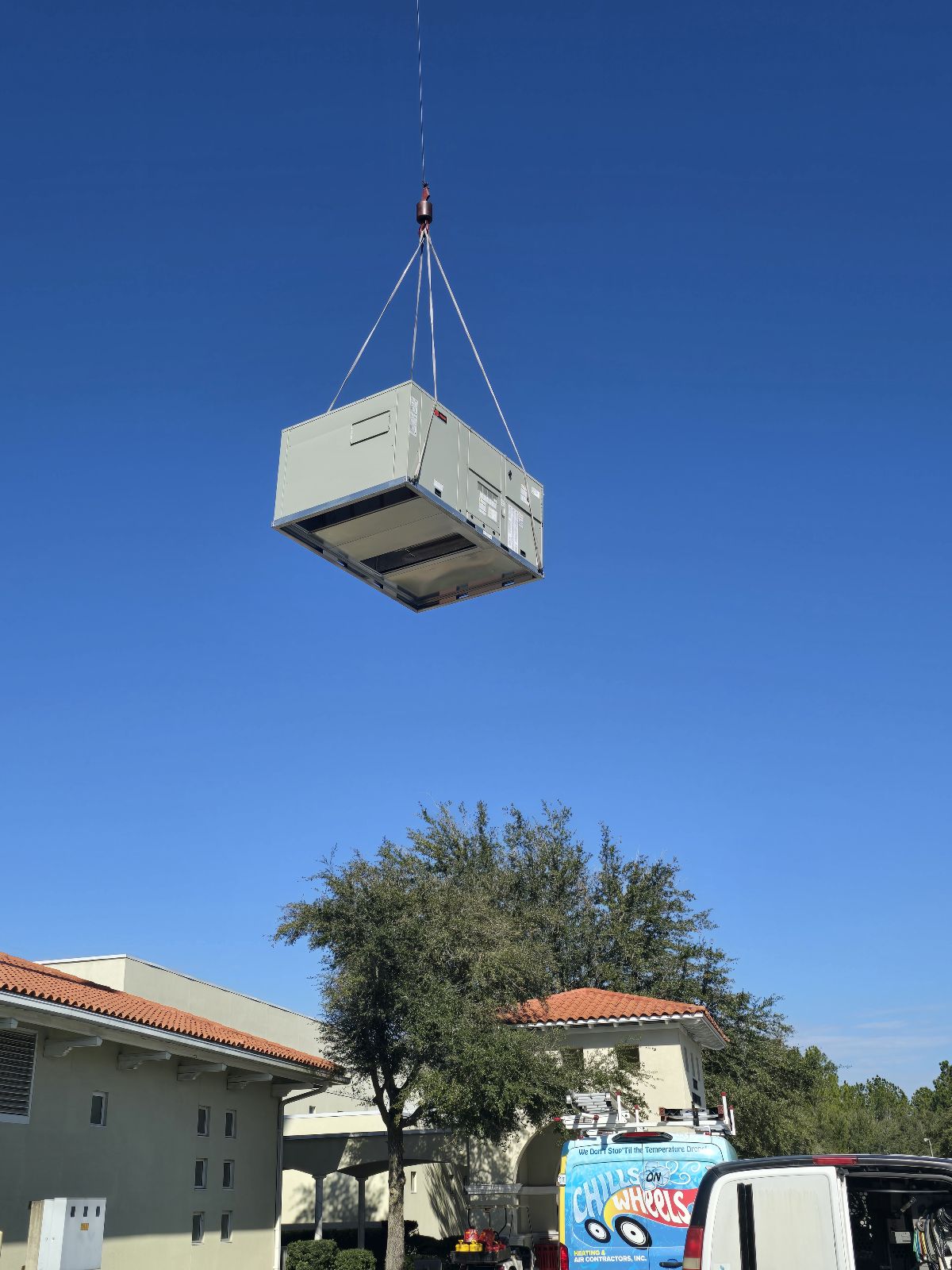 commercial ac being lowered to be installed