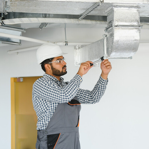 tech working on an ac duct
