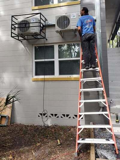 HVAC services technician works on AC units.