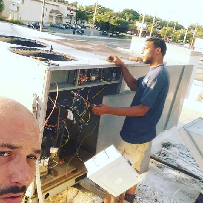 Technicians work on HVAC.
