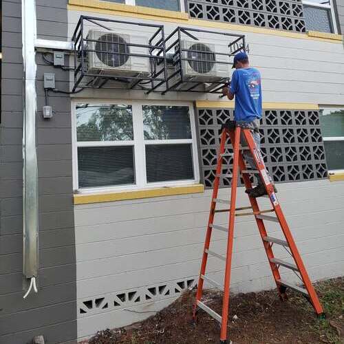 HVAC service tech installs AC.