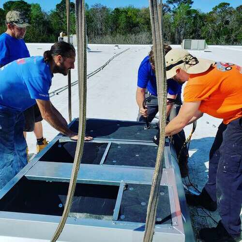 HVAC contractors install commercial unit.